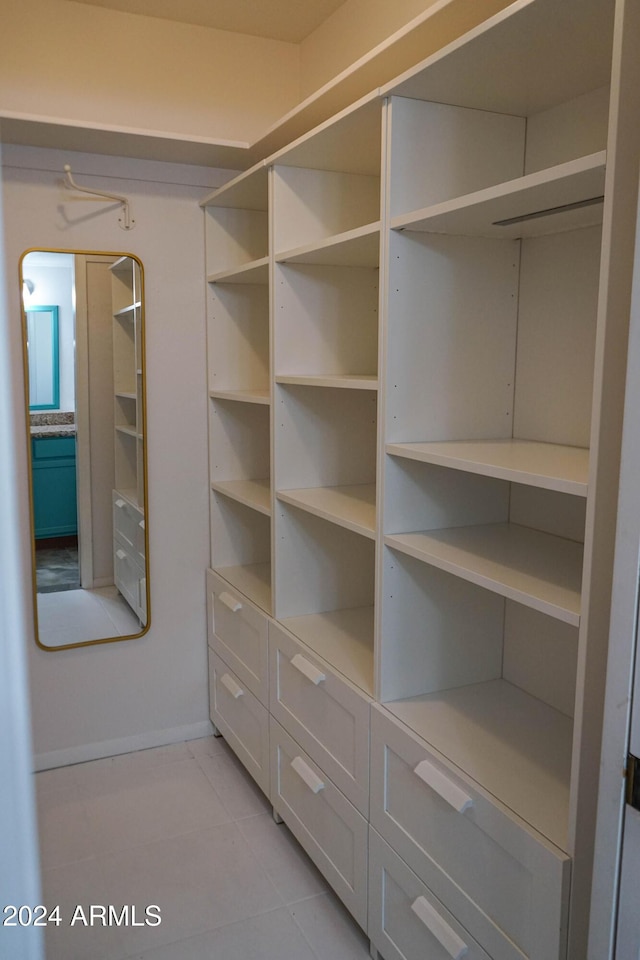 spacious closet featuring light tile patterned floors