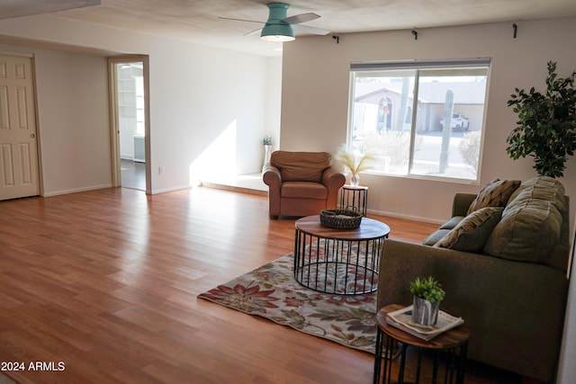 living room featuring light hardwood / wood-style flooring and ceiling fan