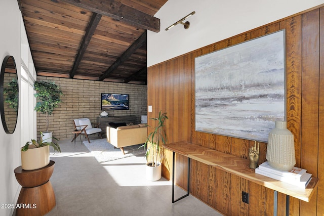 interior space featuring beamed ceiling, brick wall, wooden ceiling, and wooden walls