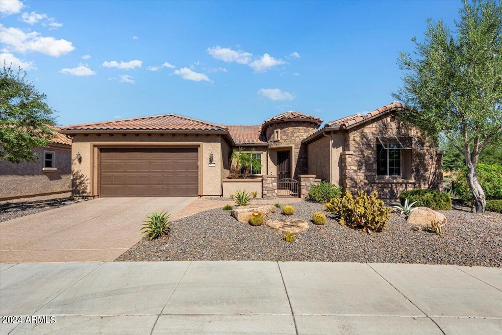 mediterranean / spanish house featuring a garage