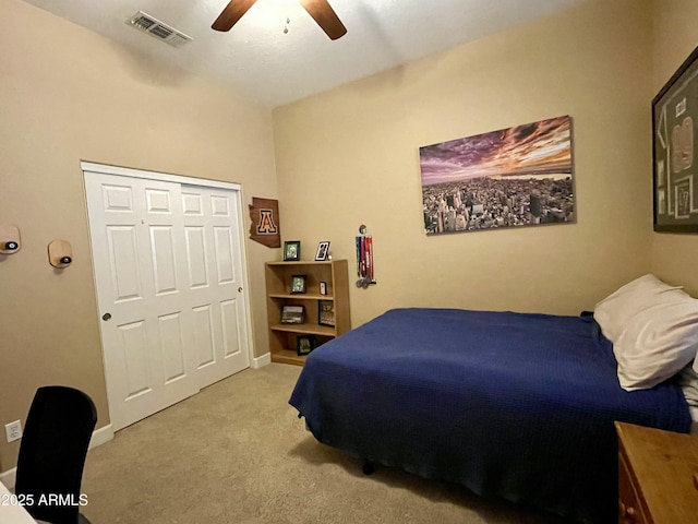 bedroom featuring ceiling fan, a closet, and light carpet