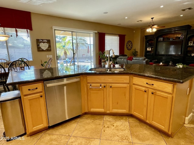 kitchen featuring dark stone countertops, sink, stainless steel dishwasher, and kitchen peninsula