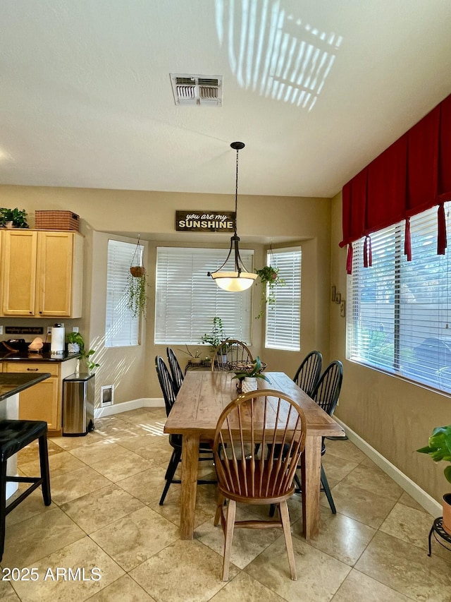 dining area featuring light tile patterned floors