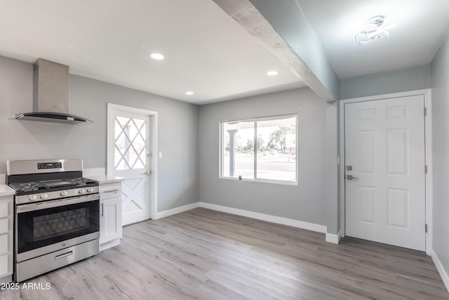 6316 N 23rd Ave, Phoenix, AZ 85015 - kitchen with stainless steel range with gas stovetop, wall chimney range hood, light countertops, light wood-type flooring, and plenty of natural light