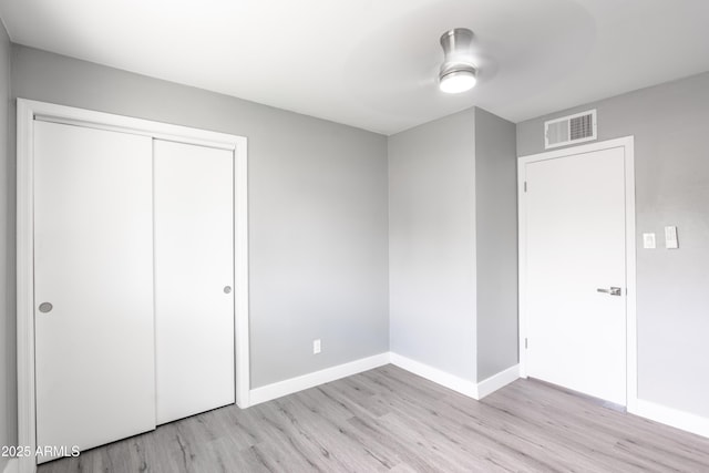 6316 N 23rd Ave, Phoenix, AZ 85015 - unfurnished bedroom featuring light wood finished floors, baseboards, a closet, and ceiling fan