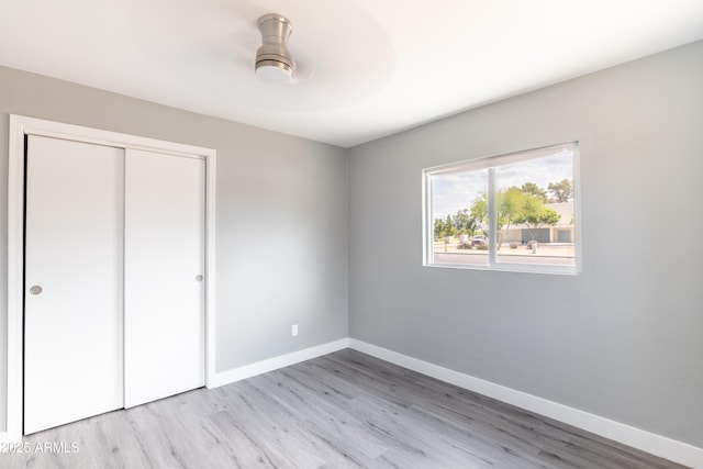 6316 N 23rd Ave, Phoenix, AZ 85015 - unfurnished bedroom with light wood-style floors, a closet, and baseboards