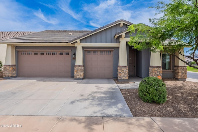 809 W Coles Rd, Phoenix, AZ 85041 - craftsman house featuring stone siding, an attached garage, concrete driveway, a tile roof, and board and batten siding