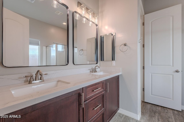 809 W Coles Rd, Phoenix, AZ 85041 - full bathroom with double vanity, wood finished floors, and baseboards