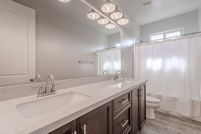 809 W Coles Rd, Phoenix, AZ 85041 - full bathroom featuring toilet, double vanity, wood finished floors, and shower / bath combination with curtain