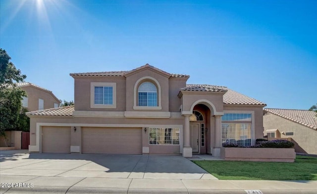 mediterranean / spanish-style house featuring a garage