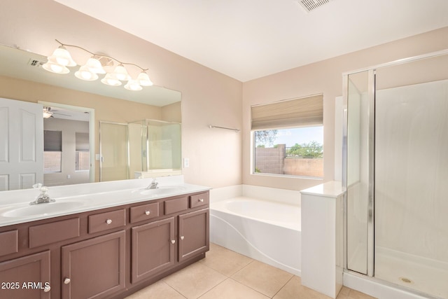 bathroom with a bath, a shower stall, a sink, and tile patterned floors