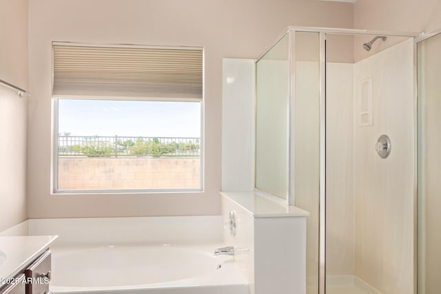 bathroom featuring a stall shower and a bath