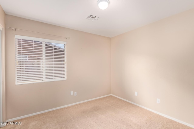 carpeted spare room with baseboards and visible vents