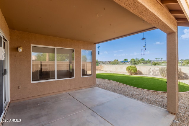 view of patio featuring fence