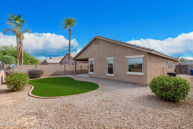 rear view of house featuring a patio area, a fenced backyard, central AC unit, and stucco siding