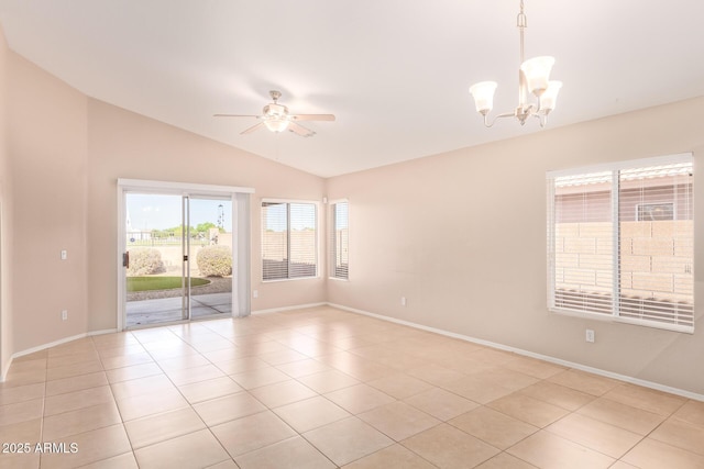 spare room with lofted ceiling, ceiling fan with notable chandelier, light tile patterned flooring, and baseboards