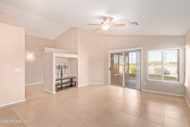 spare room with light tile patterned floors, visible vents, baseboards, vaulted ceiling, and a ceiling fan