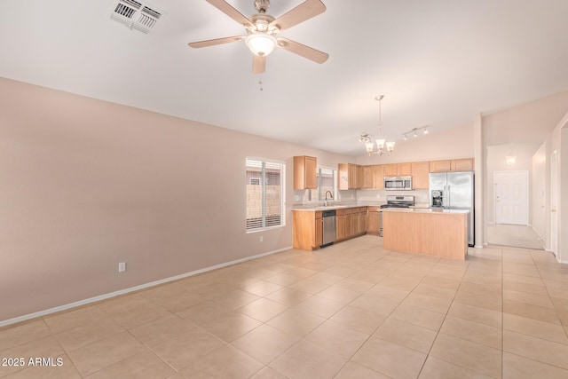 kitchen with visible vents, open floor plan, stainless steel appliances, light countertops, and light brown cabinets