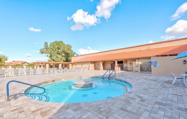 community pool with a patio and fence