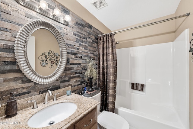 full bathroom with toilet, shower / tub combo, vanity, and visible vents