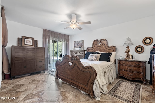 bedroom featuring stone finish floor, a ceiling fan, and access to exterior