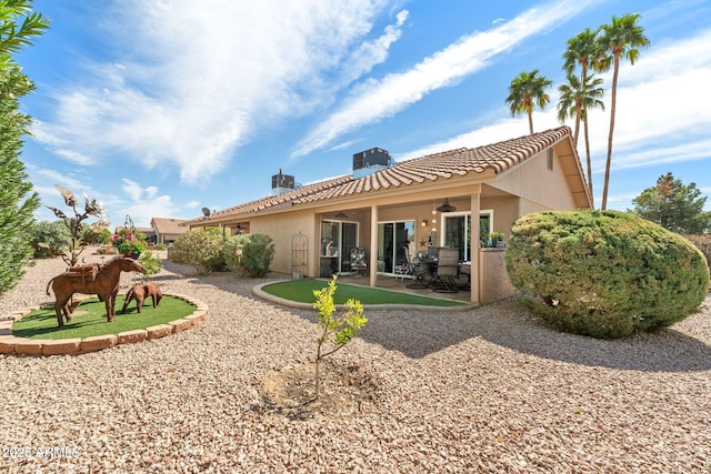 rear view of house featuring a patio area, a tile roof, a ceiling fan, and stucco siding