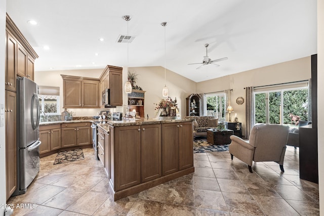 kitchen with lofted ceiling, visible vents, open floor plan, appliances with stainless steel finishes, and decorative light fixtures