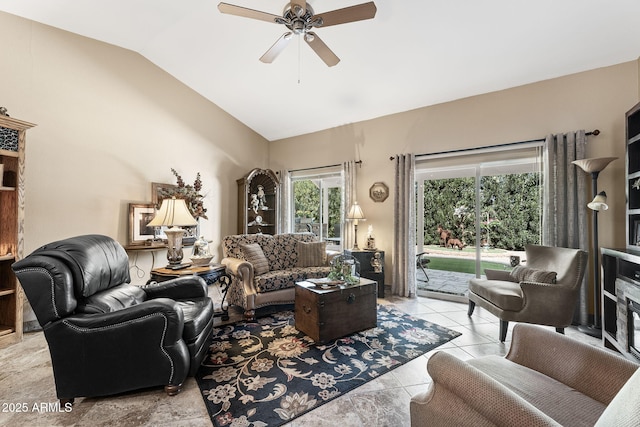 living area with lofted ceiling, ceiling fan, and light tile patterned floors