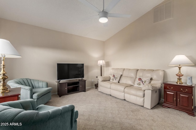 living room with ceiling fan, light carpet, and vaulted ceiling