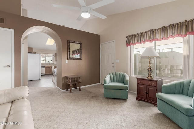 living area featuring vaulted ceiling, ceiling fan, light colored carpet, and sink