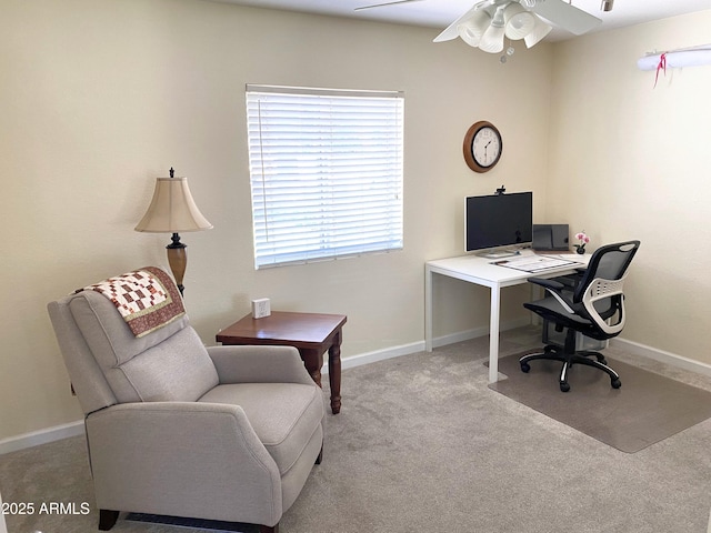 carpeted office space with ceiling fan and baseboards