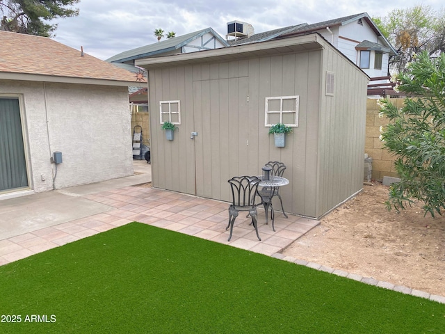 view of shed featuring fence