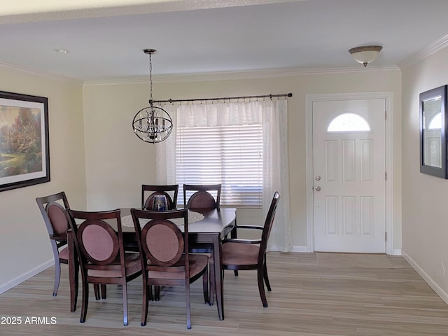 dining room featuring a chandelier, baseboards, and crown molding