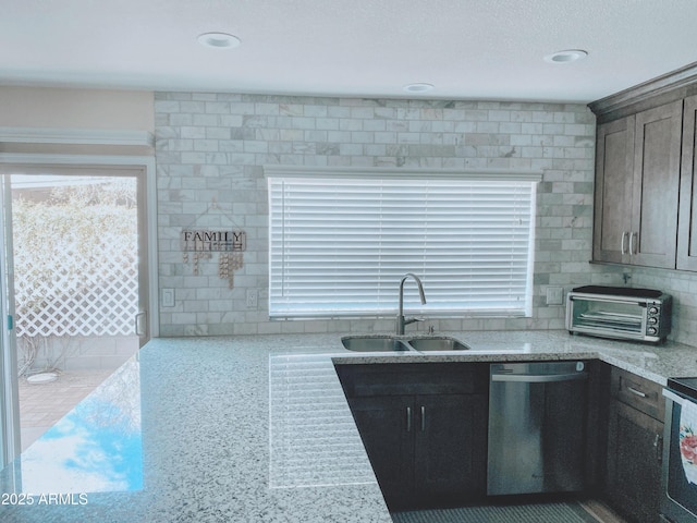 kitchen featuring a sink, a toaster, dishwasher, and recessed lighting