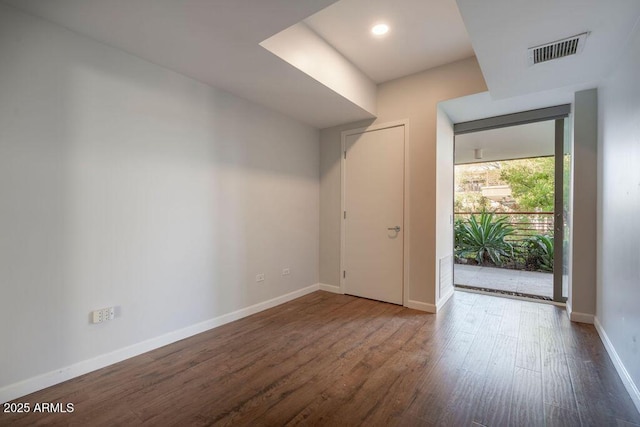 unfurnished room with dark hardwood / wood-style floors