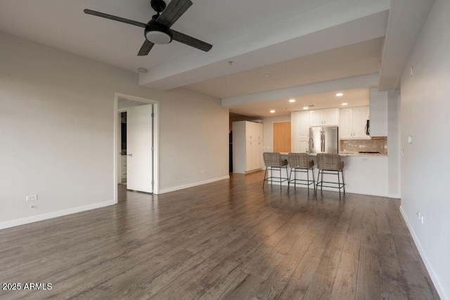 living room featuring dark hardwood / wood-style floors and ceiling fan