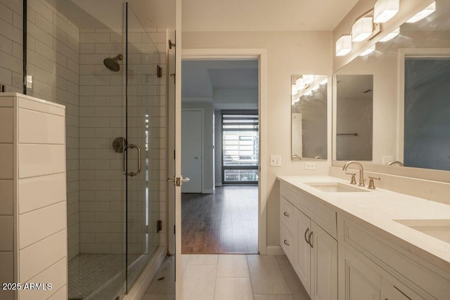 bathroom with vanity, tile patterned floors, and a shower with door