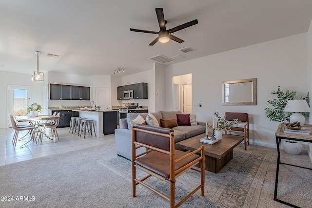 tiled living room with ceiling fan