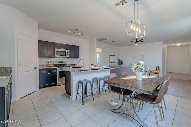 dining space featuring ceiling fan and light tile patterned floors