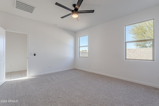 carpeted empty room featuring ceiling fan