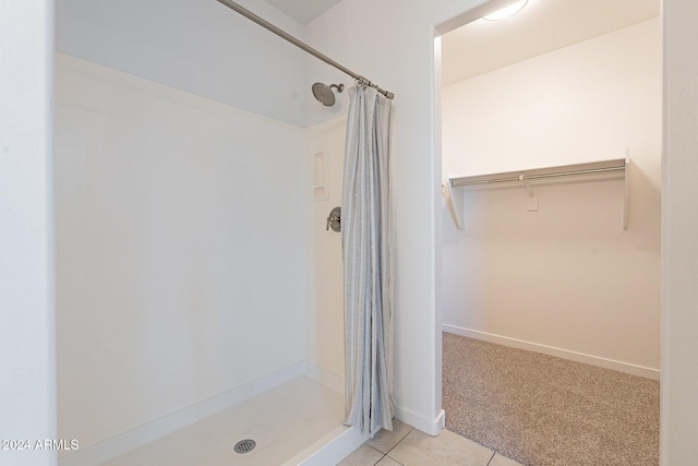 bathroom with tile patterned floors and walk in shower