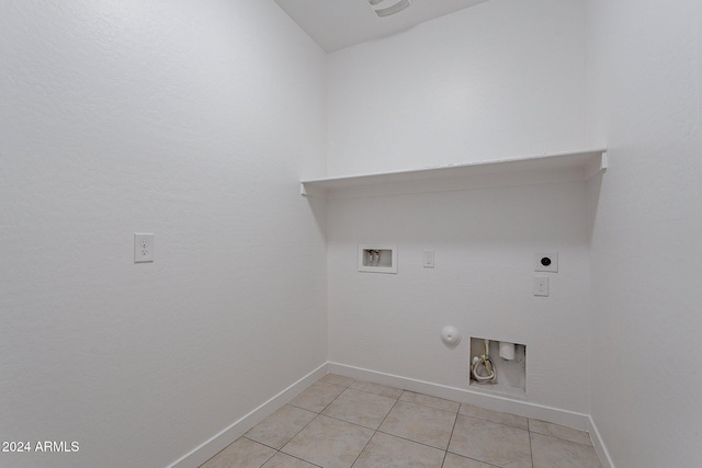 laundry room with electric dryer hookup, gas dryer hookup, light tile patterned flooring, and washer hookup