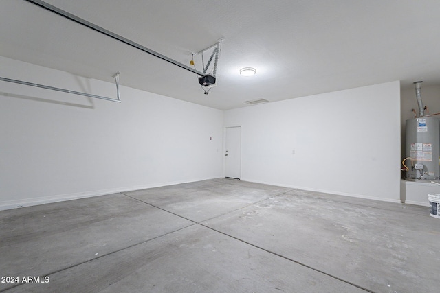 garage featuring a garage door opener and gas water heater