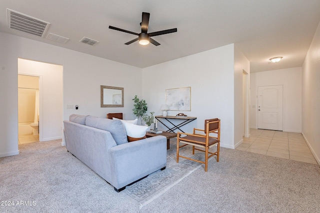 carpeted living room with ceiling fan