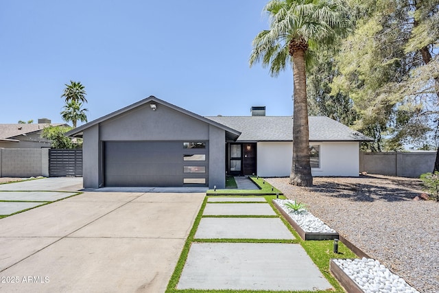 5239 E Waltann Ln, Scottsdale, AZ 85254 - view of front of home featuring concrete driveway, stucco siding, an attached garage, and a shingled roof