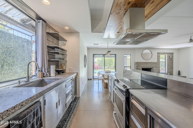 5239 E Waltann Ln, Scottsdale, AZ 85254 - kitchen with island exhaust hood, a sink, stainless steel electric range oven, open shelves, and a fireplace