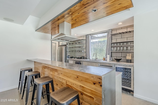 5239 E Waltann Ln, Scottsdale, AZ 85254 - indoor wet bar with beverage cooler, freestanding refrigerator, baseboards, island exhaust hood, and recessed lighting