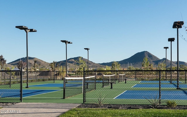 view of sport court with fence and a mountain view