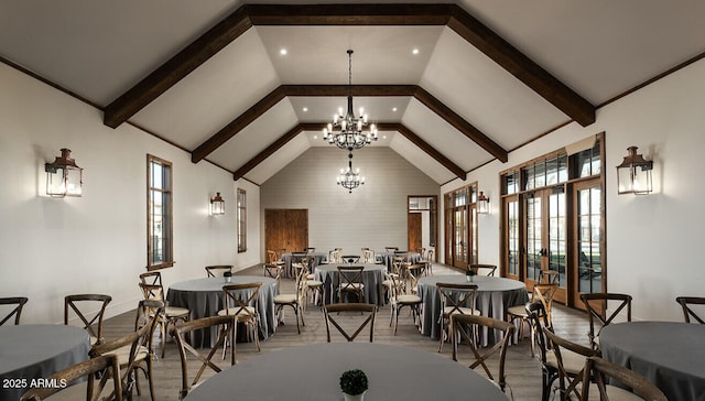 dining area featuring high vaulted ceiling, wood finished floors, beam ceiling, and a notable chandelier