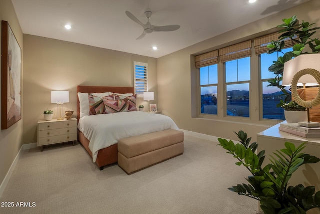 bedroom with light carpet, recessed lighting, a water view, and baseboards